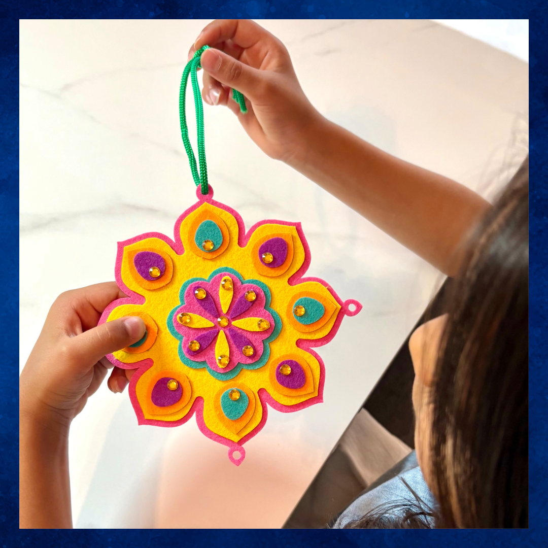 Child holding the colorful felt Pink Burfi Rangoli Mandala Celebration Wreath craft