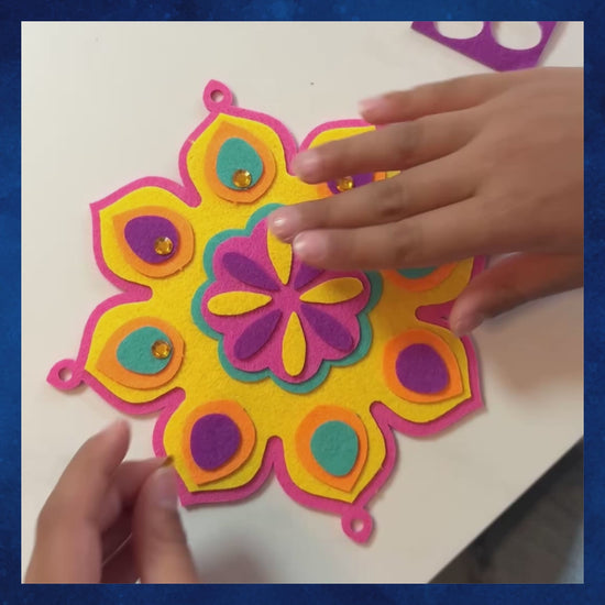 Video of child making the colorful felt Pink Burfi Rangoli Mandala Celebration Wreath craft
